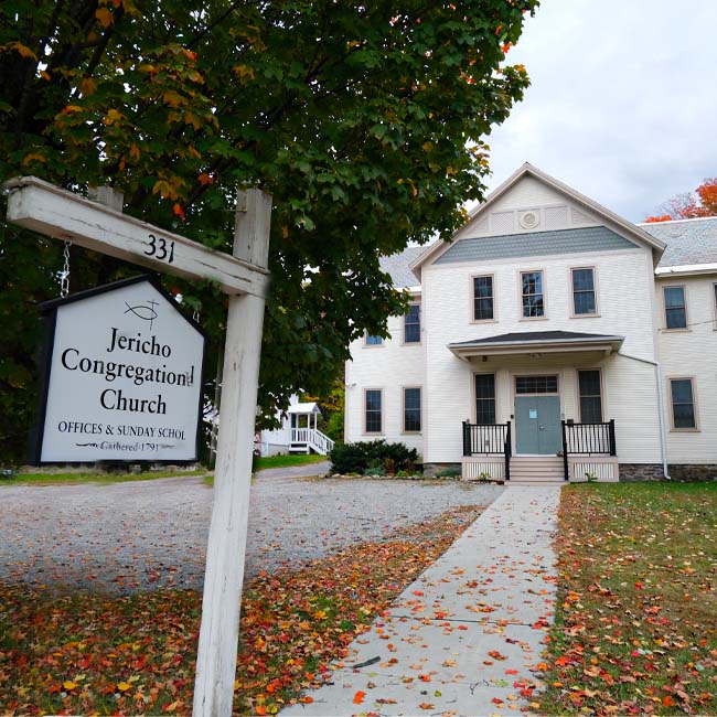 Image of the Jericho Congregational Church office building with sign out front
