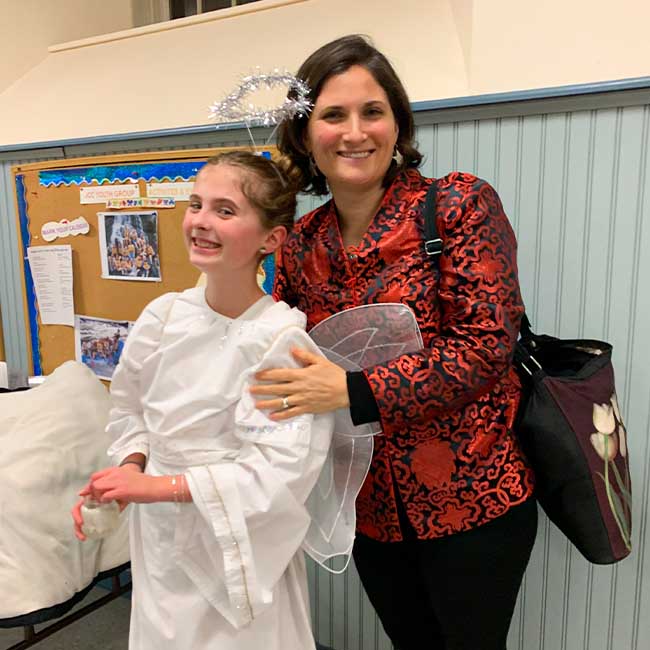 Katie with her daughter, who's dressed as an angel for the Christmas pageant