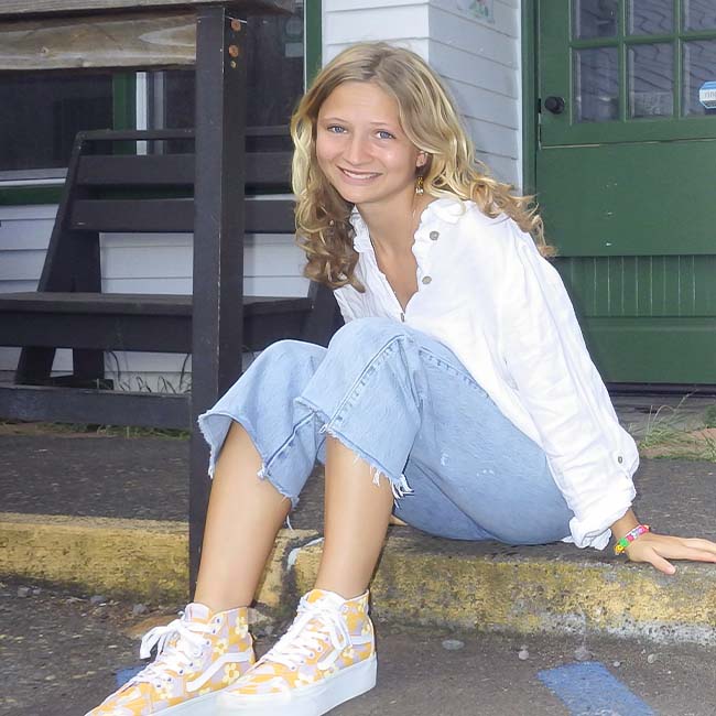 Charis sitting on step smiling